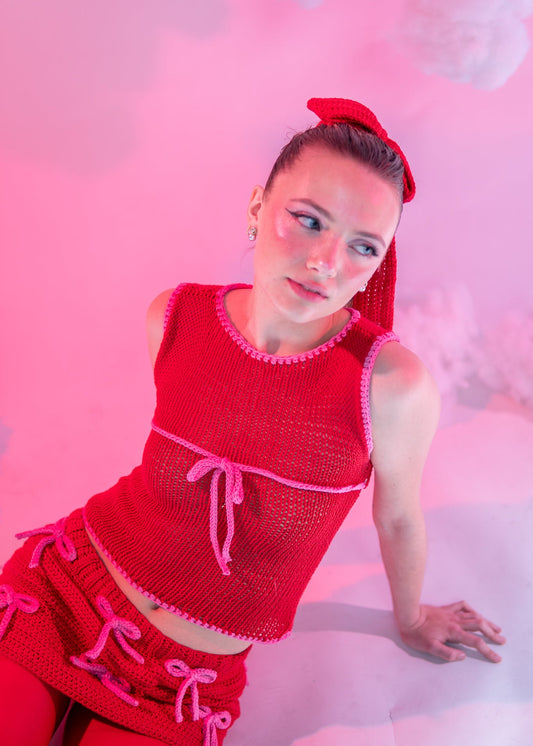 Red knit top with pink tie and trim